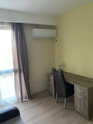 a room with a desk and a chair and a window at Grand Apartments in Bansko