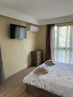 a bedroom with a bed with two towels on it at Grand Apartments in Bansko