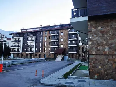 an empty parking lot in front of a building at Ski&Stay Studio Bansko in Bansko