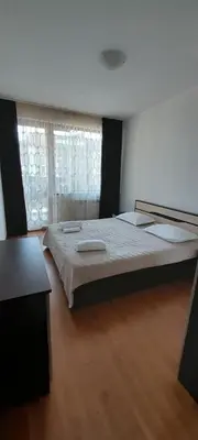a bedroom with a large bed and a window at Belvedere Holiday Club К302 in Bansko