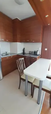 a kitchen with a white table and two chairs at Belvedere Holiday Club К302 in Bansko