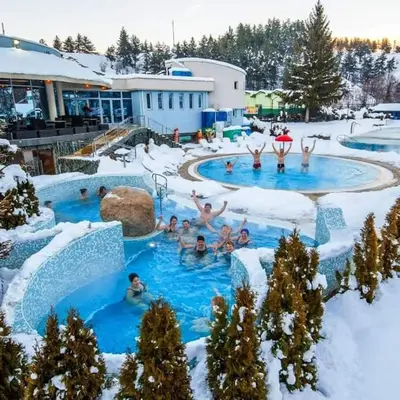 a group of people in a swimming pool in the snow at Belvedere Holiday Club К302 in Bansko