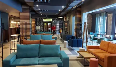 a store with blue couches and tables and chairs at B55 Studio in Borovets
