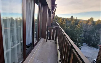 a balcony of a house with a view of trees at B55 Studio in Borovets