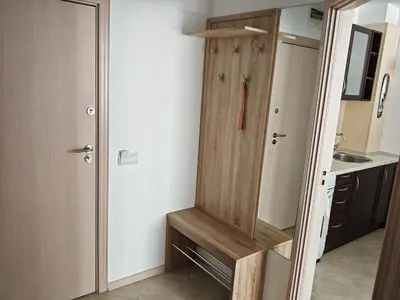 a small kitchen with a sink and a wooden door at Gondola Ski Lift Apartment in Bansko