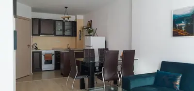 a kitchen and dining room with a table and chairs at Gondola Ski Lift Apartment in Bansko