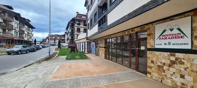 a building with a sign on the side of a street at Gondola Ski Lift Apartment in Bansko
