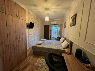 a small bedroom with a bed and a table at Elegant and cozy room ARAKS in Kostinbrod