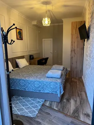 a bedroom with a bed with a blue bedspread at Elegant and cozy room ARAKS in Kostinbrod