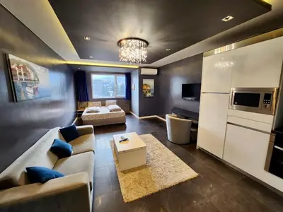 a large living room with a couch and a table at Joy Station Cozy Studio in Sofia