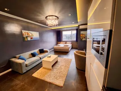 a living room with a couch and a table at Joy Station Cozy Studio in Sofia