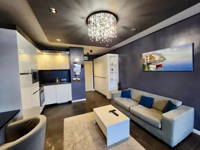 a living room with a couch and a table at Joy Station Cozy Studio in Sofia