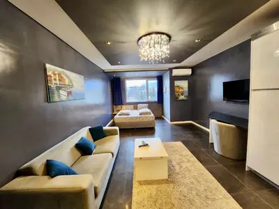 a living room with a couch and a table at Joy Station Cozy Studio in Sofia