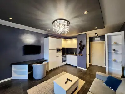 a living room with a couch and a table at Joy Station Cozy Studio in Sofia