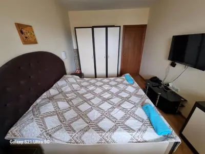 a bedroom with a bed with a quilt on it at Suite Roma 2 at Spa Club Bor in Velingrad