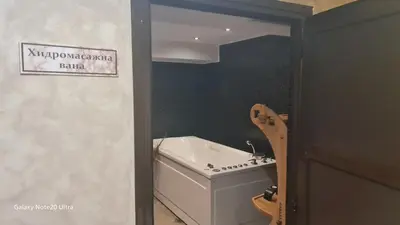 a bathroom with a toilet and a sink and a guitar at Suite Roma 2 at Spa Club Bor in Velingrad