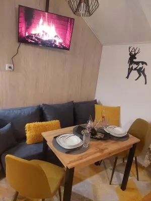 a living room with a table and a couch at Premium mountain studio 40 Semiramida Gardens in Borovets