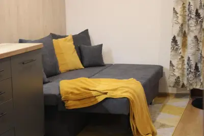 a bedroom with a bed with a yellow blanket on it at Premium mountain studio 40 Semiramida Gardens in Borovets