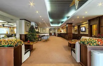 a hospital lobby with couches and a christmas tree at Dino privates apartments Emerald in Bansko