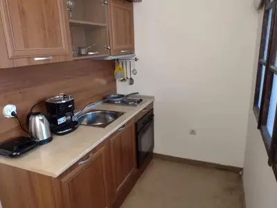 a small kitchen with a sink and a microwave at Dino privates apartments Emerald in Bansko