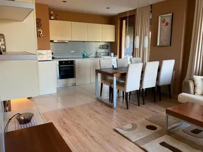 a kitchen and dining room with a table and chairs at Апартамент за гости Свети Трифон in Pamporovo