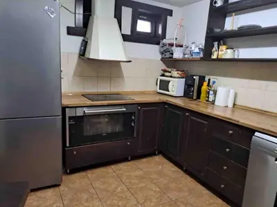 a kitchen with a stove and a refrigerator at House Trivia in Bansko