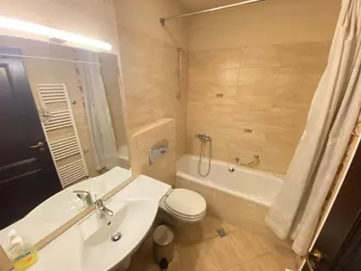 a bathroom with a sink and a toilet and a tub at House Trivia in Bansko