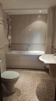 a bathroom with a tub and a toilet and a sink at Annett apartments at Emerald hotel in Bansko