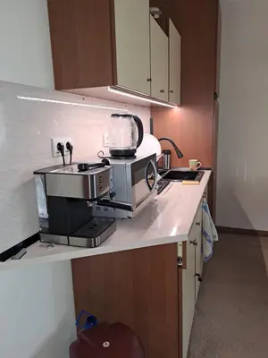 a kitchen with a stove and a microwave on a counter at Annett apartments at Emerald hotel in Bansko