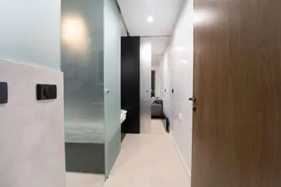 a hallway with a room with a bed and a door at Stylish Cozy Studio with fireplace in Bansko