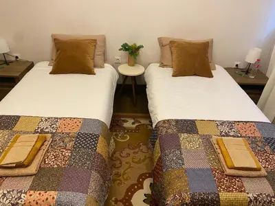two beds sitting next to each other in a room at City centre stylish apartament with private backyard in Sofia