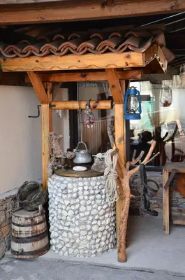 a wooden structure with a pot on top of a pile of rocks at Bóris House in Ognyanovo