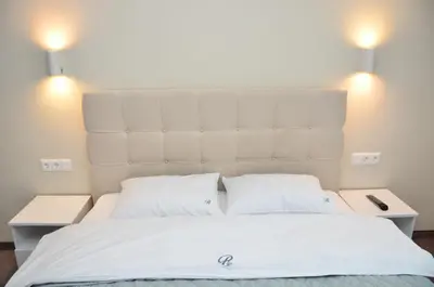 a bedroom with a large white bed with two pillows at Bóris House in Ognyanovo