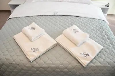 a bed with two towels on top of it at Bóris House in Ognyanovo