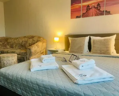 a bedroom with a bed with towels on it at Bóris House in Ognyanovo