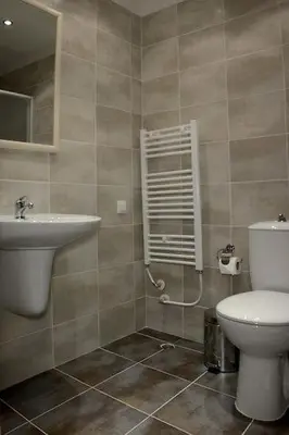 a bathroom with a toilet and a sink at Парк хотел Кюстендил in Kyustendil