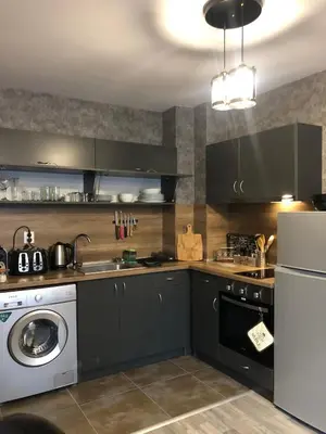 a kitchen with a washing machine and a washer at Luxury Apartments Studenets in Pamporovo