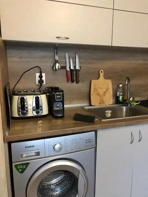 a kitchen with a washing machine and a sink at Luxury Apartments Studenets in Pamporovo