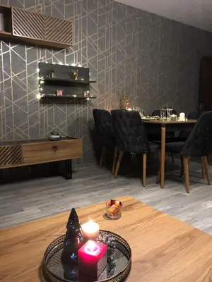 a living room with a table with a candle on it at Luxury Apartments Studenets in Pamporovo