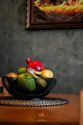 a bowl of fruit on top of a table at Deluxe Apartment 33 Mountain Lodge Pamporovo in Pamporovo