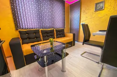 a living room with a couch and a glass table at Apartament Tiana Lux in Hisarya