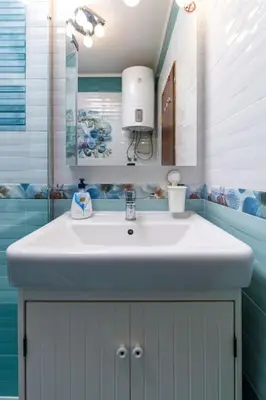 a bathroom with a white sink and a mirror at Dufti Home in Plovdiv Center & Old Town / Kapana in Plovdiv