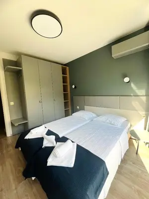 a bedroom with a large bed with towels on it at 7th Sense boutique apartments in Sofia
