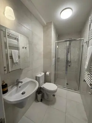a bathroom with a toilet and a shower and a sink at 7th Sense boutique apartments in Sofia