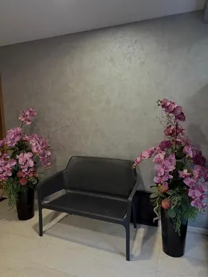a black bench sitting next to two potted plants at 7th Sense boutique apartments in Sofia