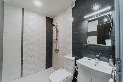 a bathroom with a toilet and a sink and a mirror at Katerina Apartments 2 in Velingrad
