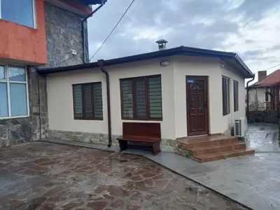 a small house with a porch and a door at Къща за гости Елит (Guest House Elite) in Sapareva Banya