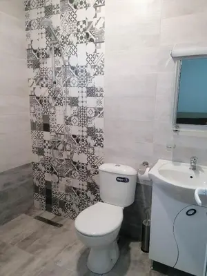 a bathroom with a toilet and a sink at Къща за гости Елит (Guest House Elite) in Sapareva Banya