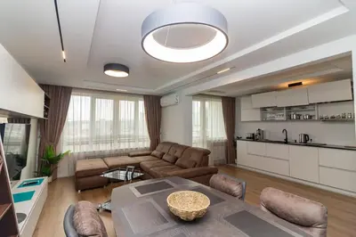 a living room with a couch and a table at Gran Capital Top Central Apartment in Sofia