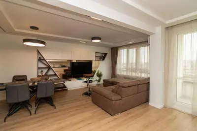 a living room with a couch and a table at Gran Capital Top Central Apartment in Sofia